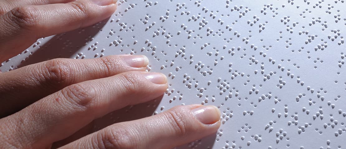 Fingers reading braille