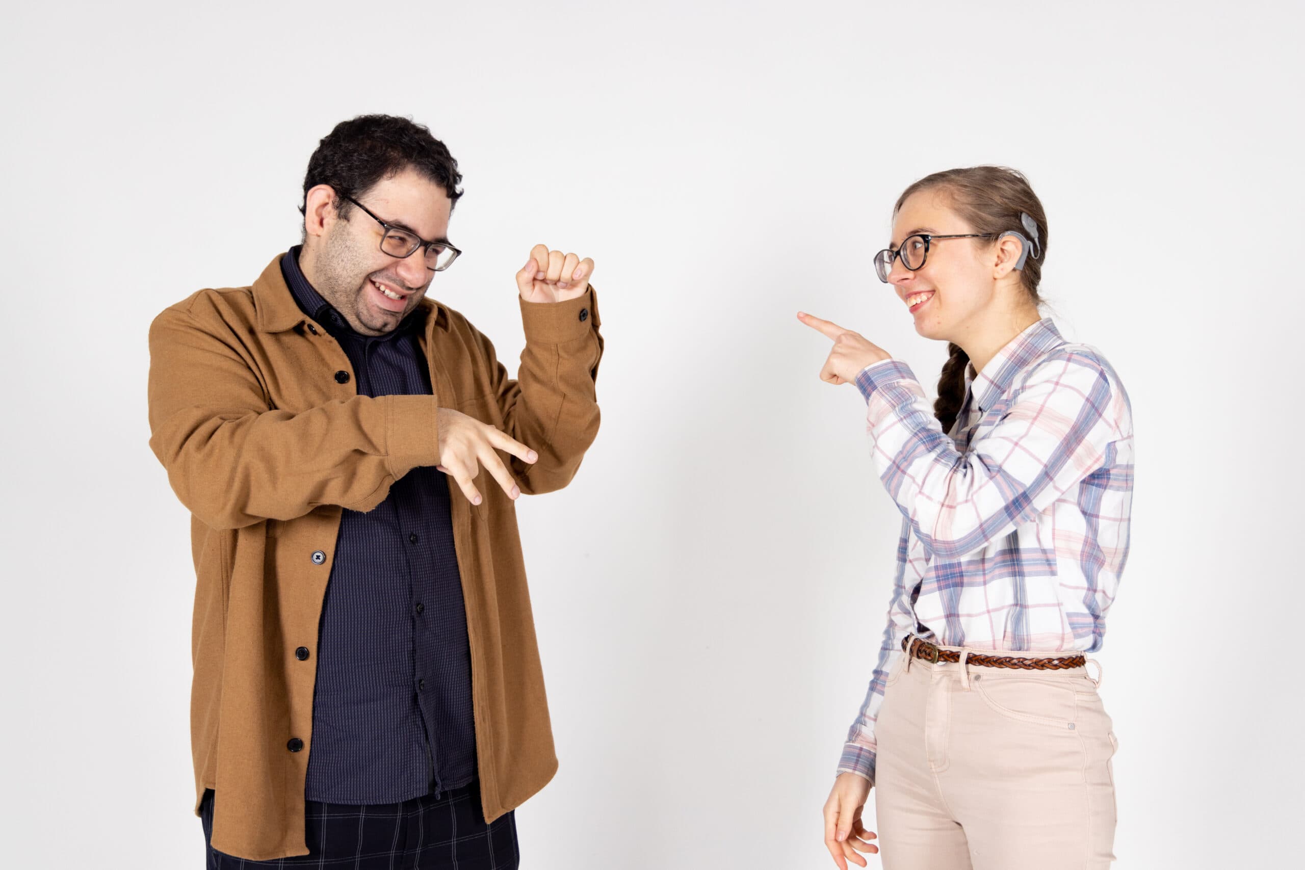 Deafblind clients, Savanna and Poreia communicate using sign language. It looks like they're having a good chat.