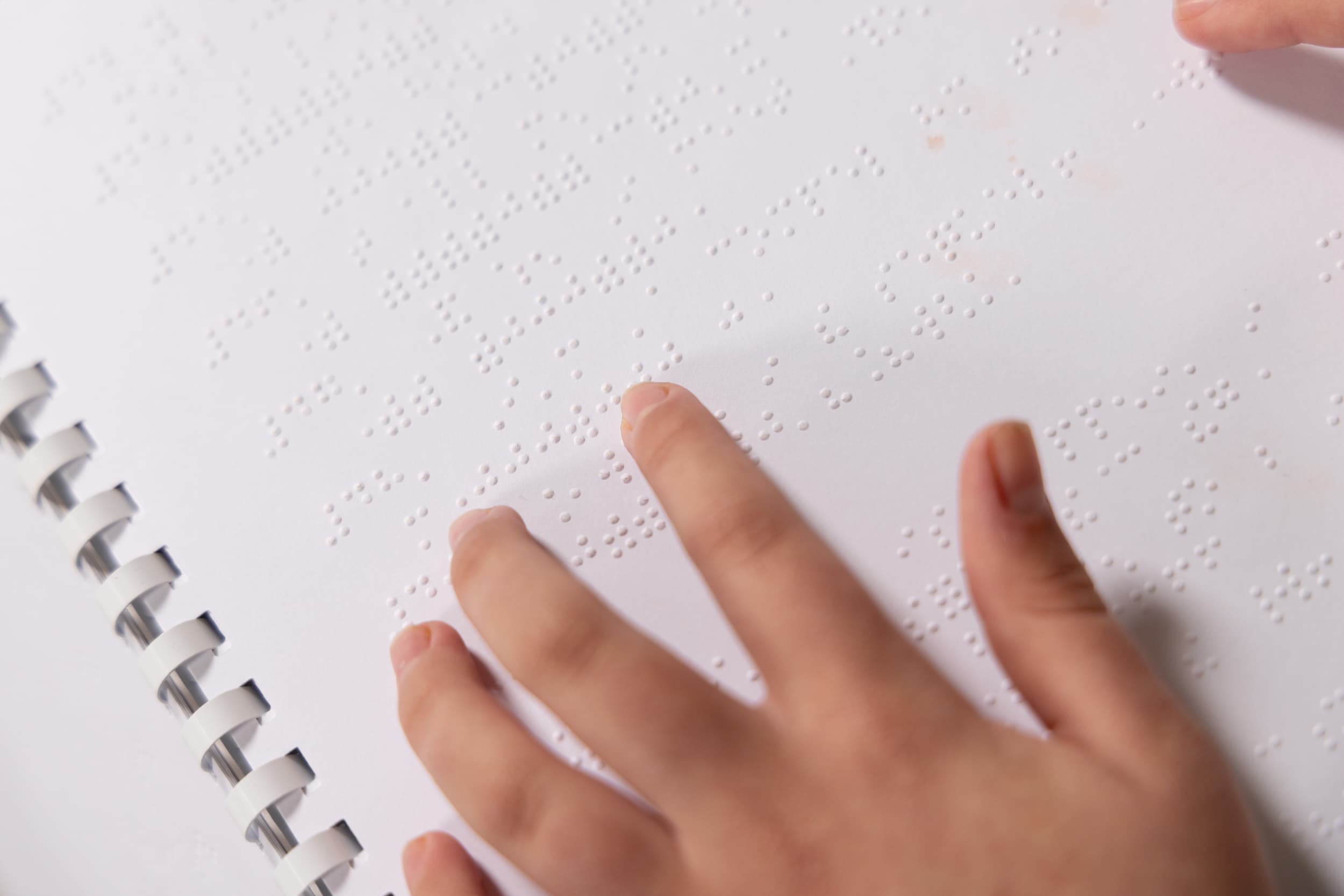 Fingers reading braille