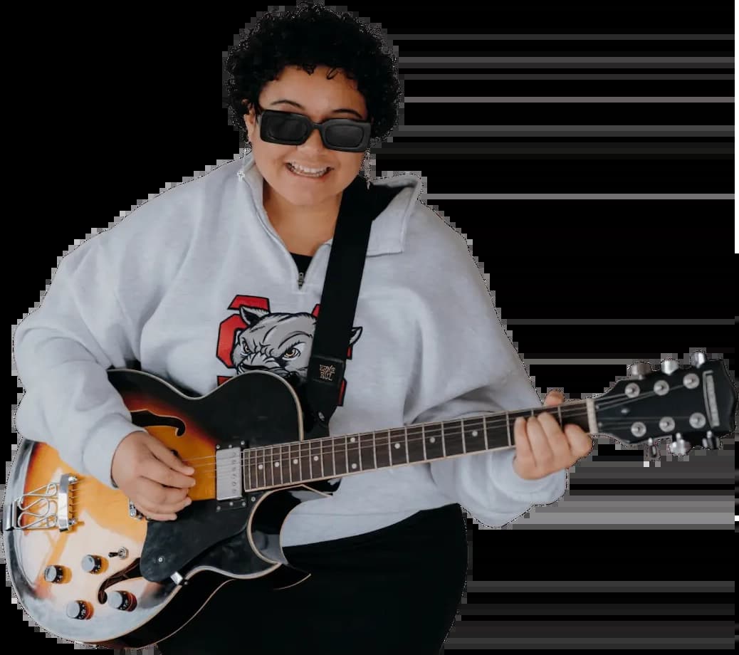 female playing guitar