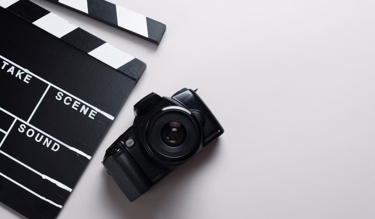 A photograph of a camera and clapperboard.