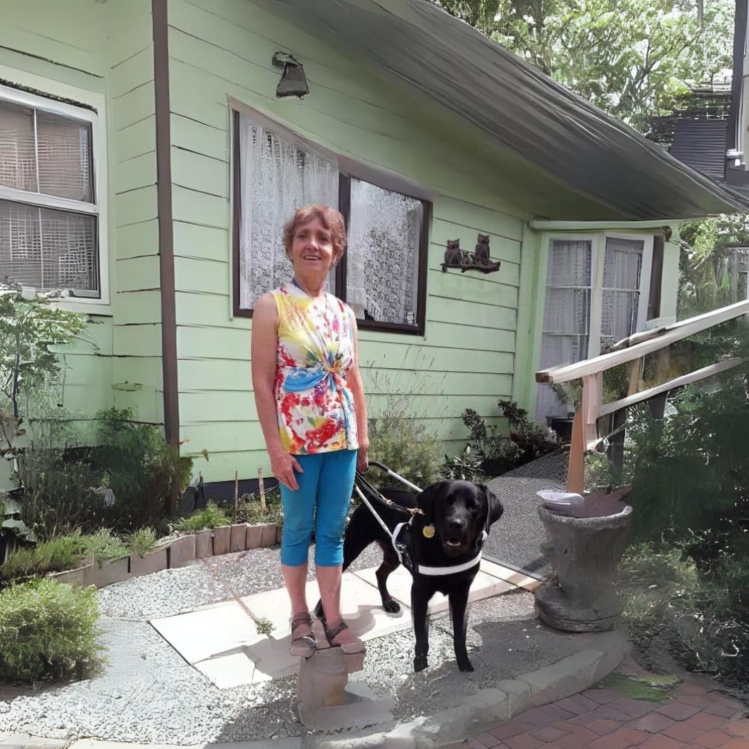 Verna and her guide dog Gilbert outside Verna's home.