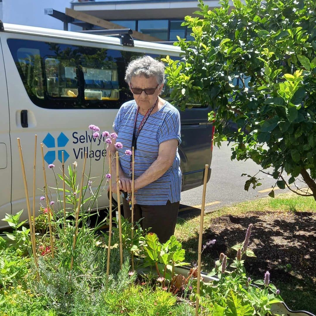 Blind Low Vision NZ client, Marie in her garden.