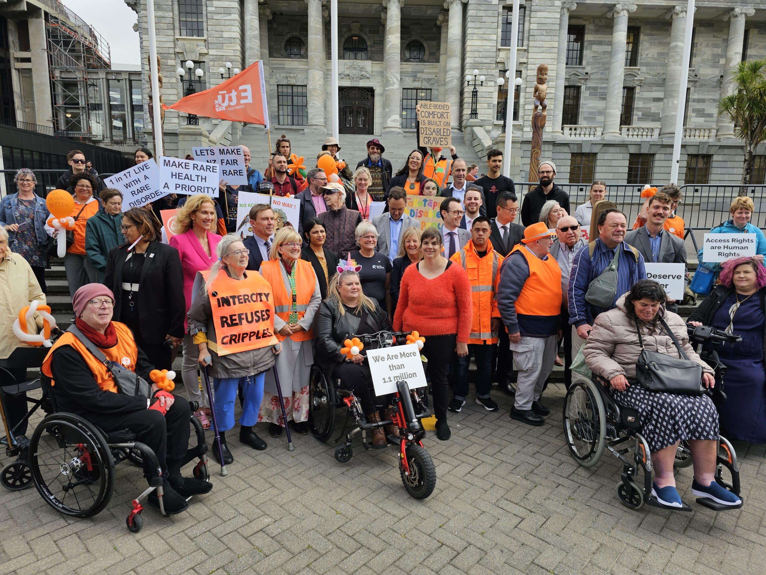 A group of disability advocates outside the Beehive in Wellington New Zealand.