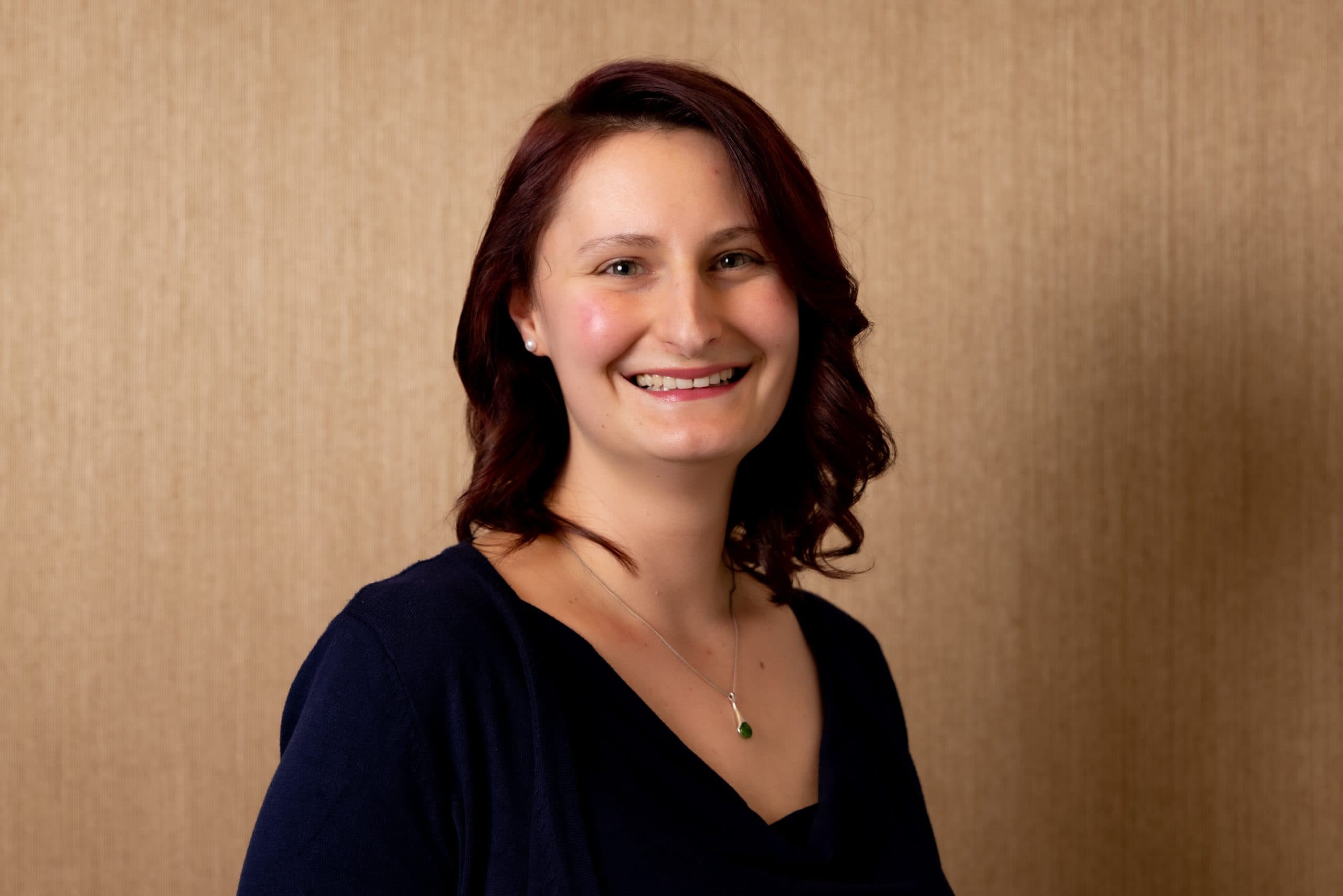 Jelena Zidov, Head of Policy and Advocacy at Blind Low Vision NZ in an indoor setting, smiling for the camera.