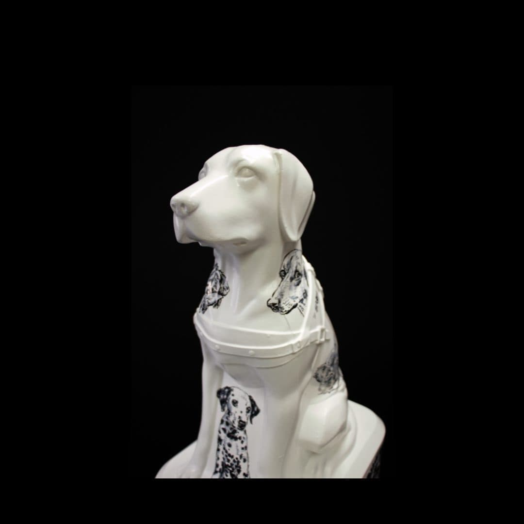 A Blind Low Vision NZ Trudy Dog decorated with black-and-white dog motifs, set against a black background.
