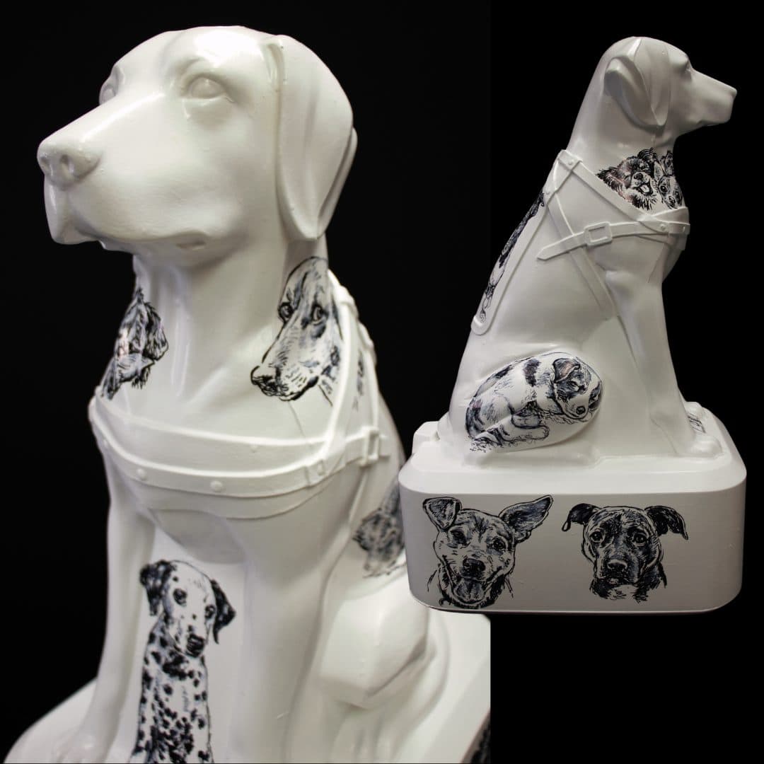 A Blind Low Vision NZ Trudy Dog decorated with black-and-white dog motifs, set against a black background. Front and side profiles are presented.
