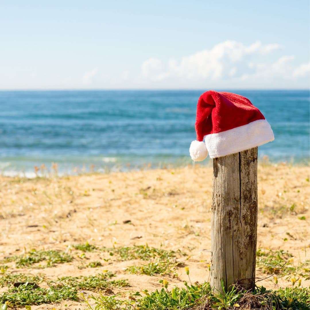 A Santa hat on a post at the beach