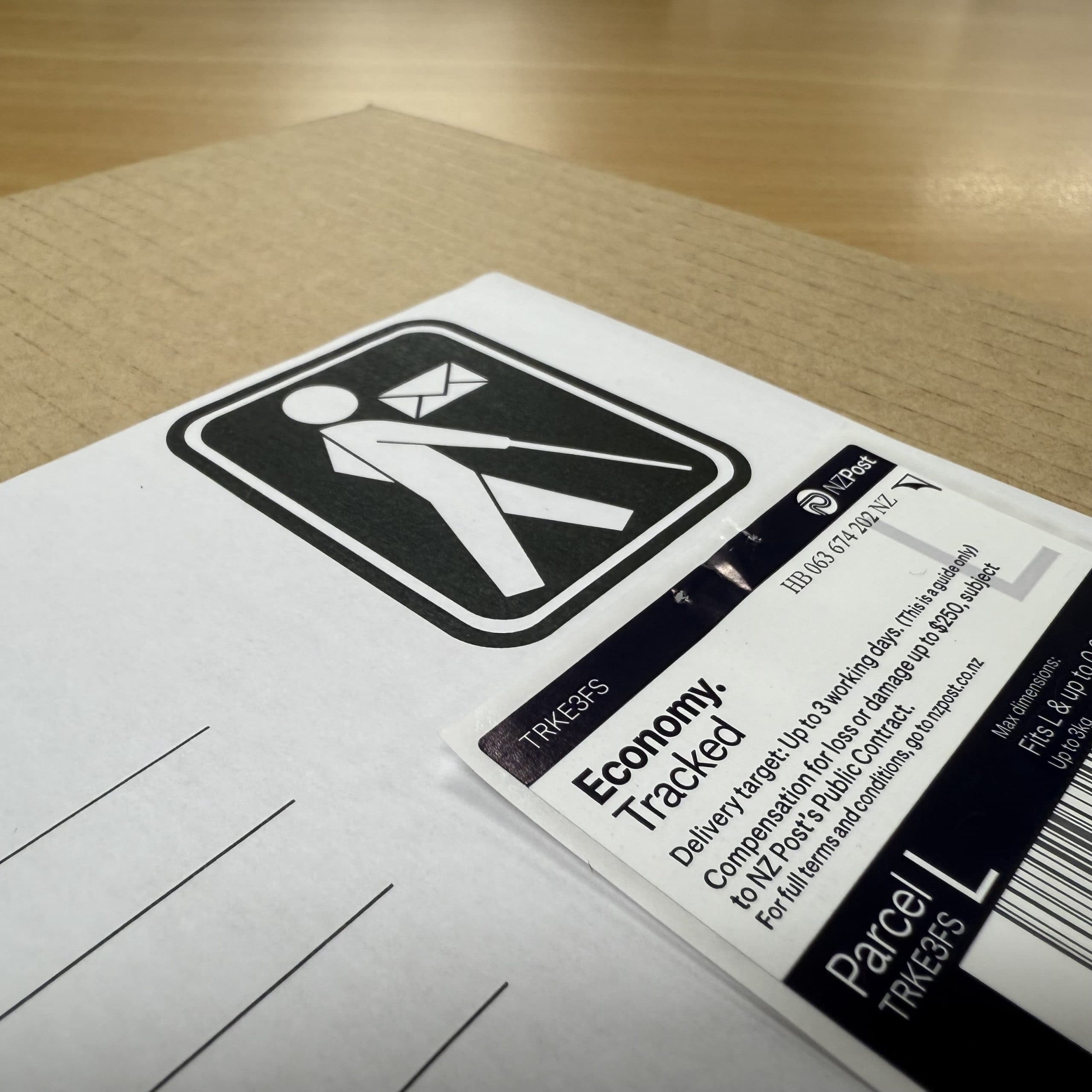 A manila envelope with an image of a man with a white cane on the top right corner.