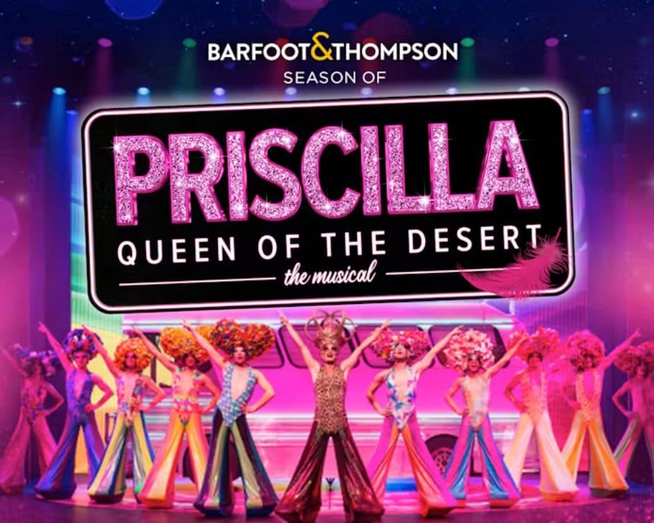 Priscilla Queen of the Desert. An image of a brightly lit stage with a cast of colourful characters on it, hands in the air.