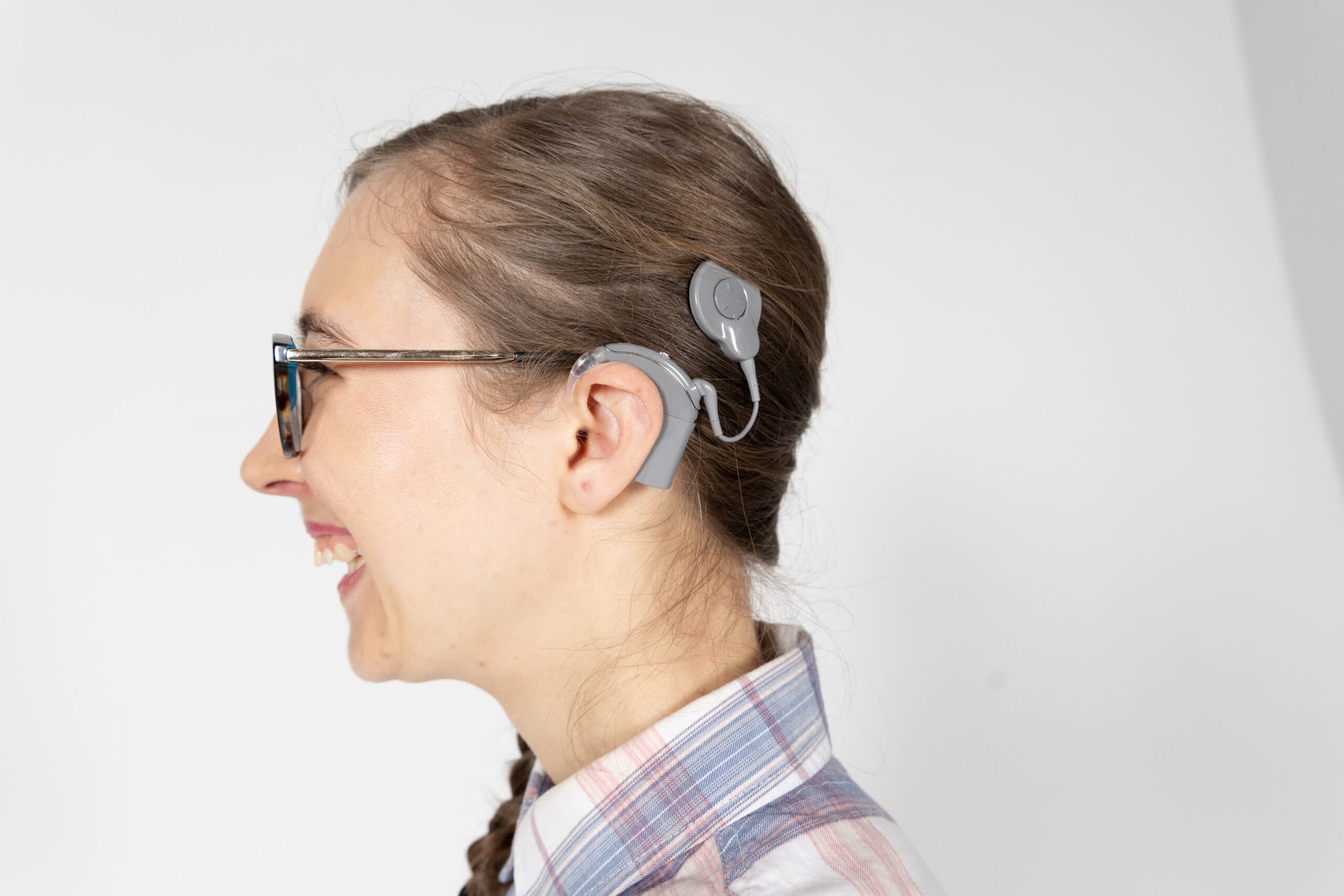 Deafblind client Savanagh faces the left hand side and showing her cochlear implant