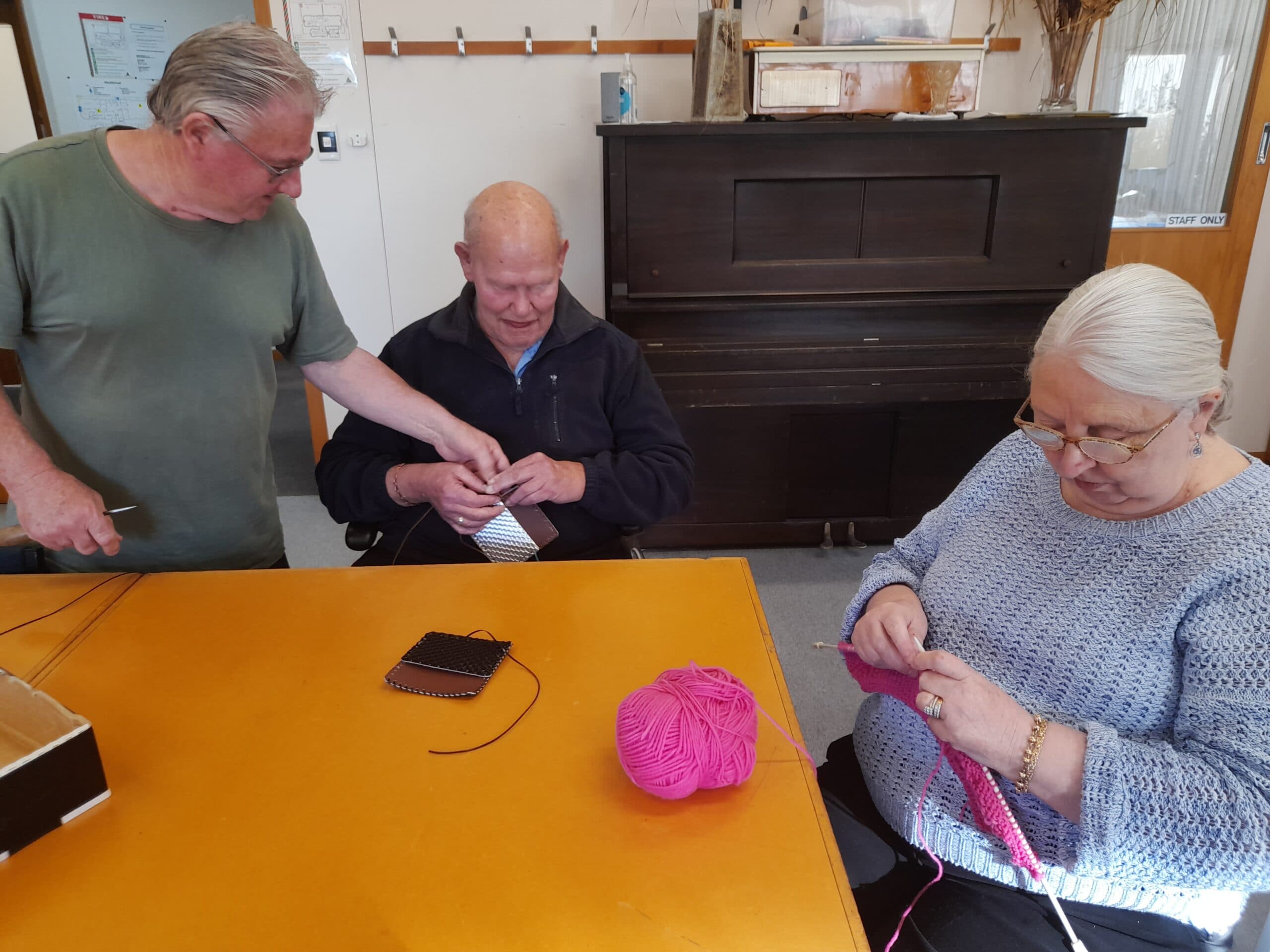 A group of clients are holding a knitting circle