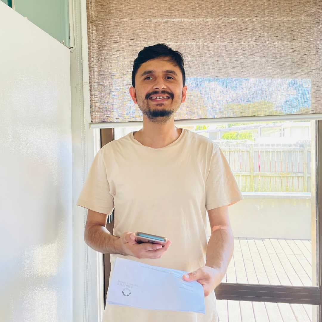 Bijay smiles at the camera, happy that he connected with Sarah at Youth and Transition, thanks to your support.