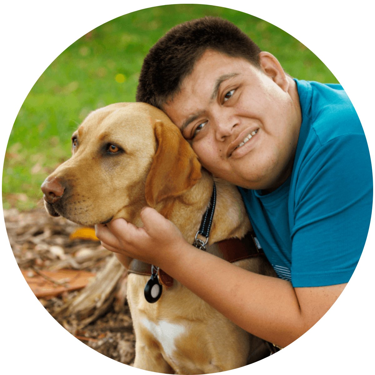 A close up of a young man hugging his guide dog.
